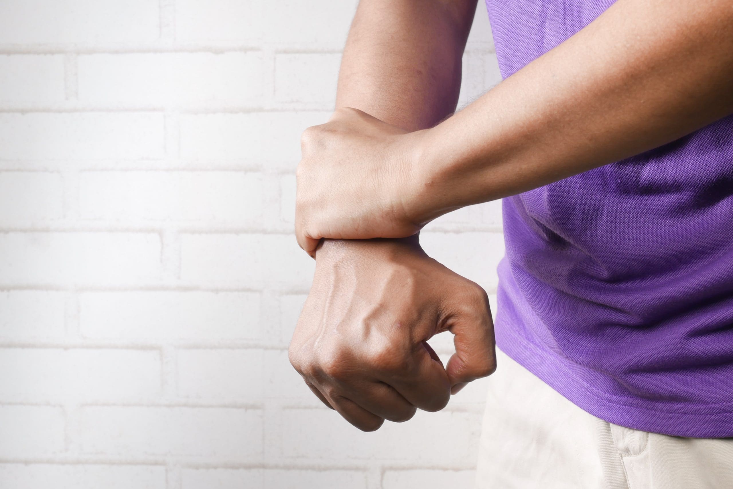 man-wrist-pain Man holding his wrist that it's pain