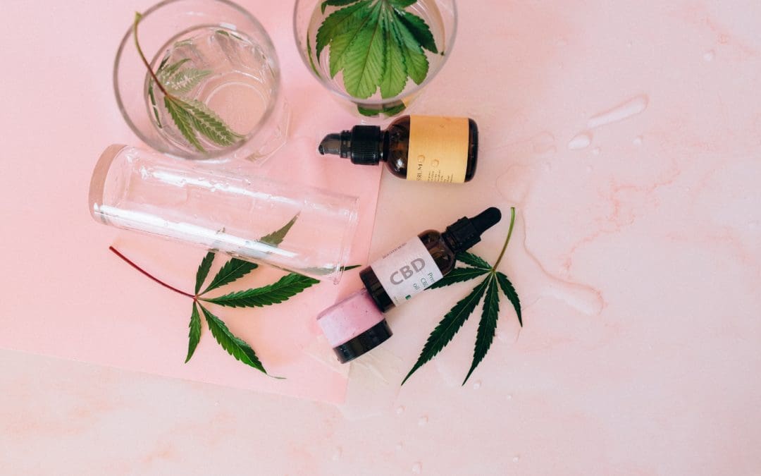 Topical cannabis serum bottles and cannabis leaves